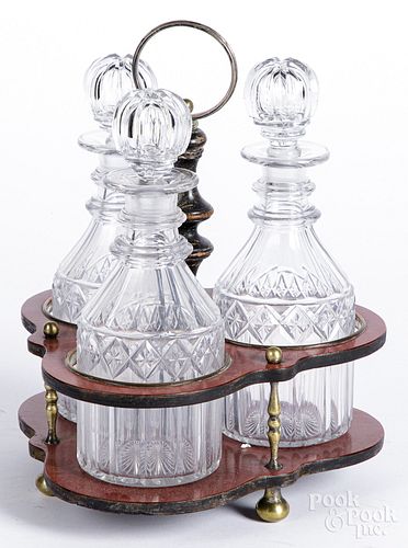Red lacquer cruet stand, with cut glass bottles.