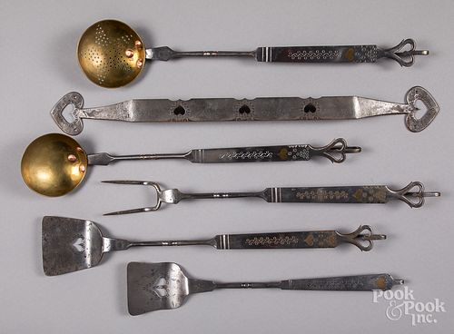 Set of wrought iron and brass kitchen utensils.