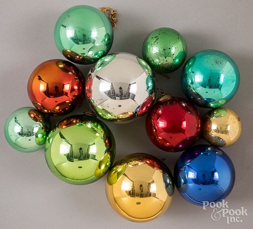 Eleven Kugel glass Christmas ornaments.