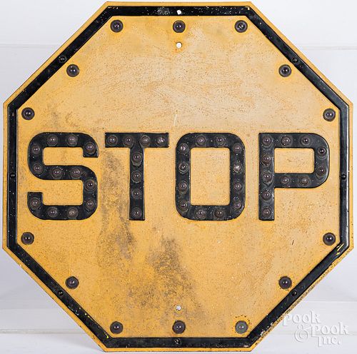 Yellow jeweled cats eyes stop sign