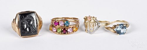 Four 10K gold and gemstone rings