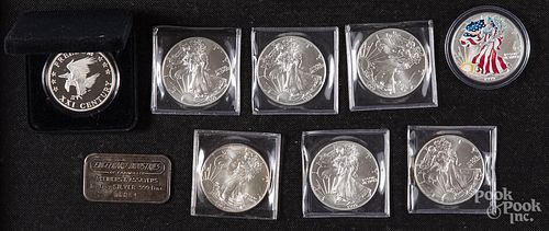 Nine 1 ozt. fine silver coins and ingots.