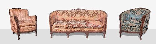 A Heavily Carved and Upholstered Sofa and Two Club Chairs, 20th Century.