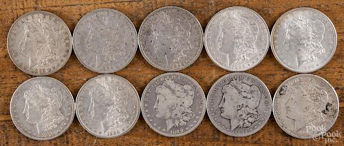 Ten Morgan silver dollars of various dates and conditions, 1884-1921.