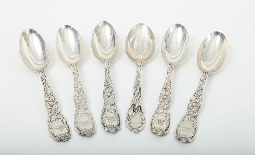 FIVE TIFFANY & CO. MONOGRAMMED SILVER SOUP SPOONS, IN THE CHRYSANTHEMUM PATTERN AND A REED AND BARTON SLOTTED SPOON WITH LILY-CHASED HANDLE