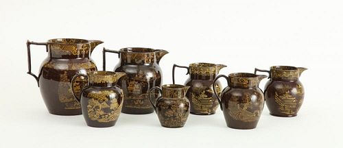 GROUP OF SEVEN STAFFORDSHIRE YELLOW-DECORATED BROWN-GLAZED PITCHERS
