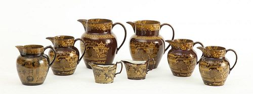 TWO STAFFORDSHIRE YELLOW-DECORATED BROWN-GLAZED CREAMERS AND SIX MILK OR CREAM JUGS
