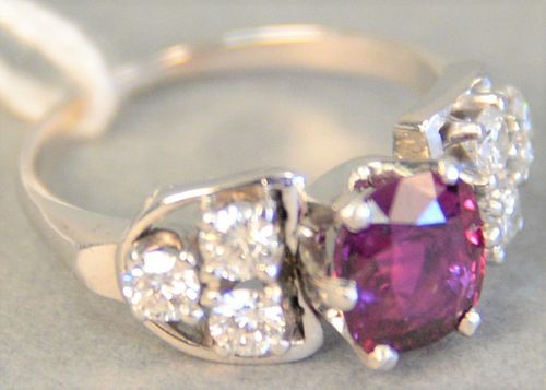 White gold ring set with center oval ruby flanked by 3 diamonds on either side, size 6 1/2.