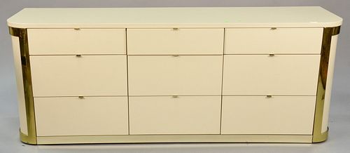 John Stewart nine-drawer commode, mid-century design, graduated drawers with brass tab pulls, lacquered finish, gold metal trim, signed in drawer, ht.