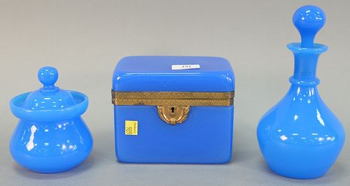 Three pieces of blue opaline glass, including: decanter with stopper, 9" h.; covered jar, 5 1/2" h.; and large blue opaline box with lid, gilt brass e