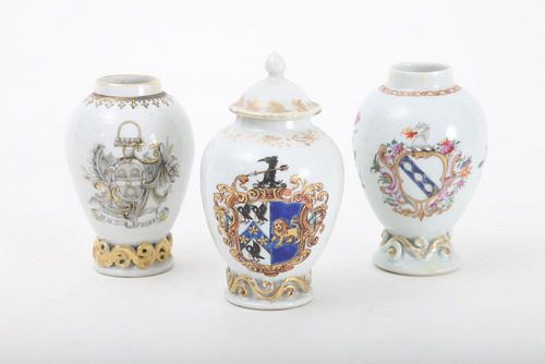 CHINESE EXPORT ARMORIAL PORCELAIN TEA CADDY AND ASSOCIATED COVER AND TWO SIMILAR CADDIES