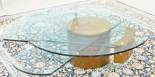 Dakota Jackson, self-winding coffee table, has three moving glass components, ht. 17", dia. 54".