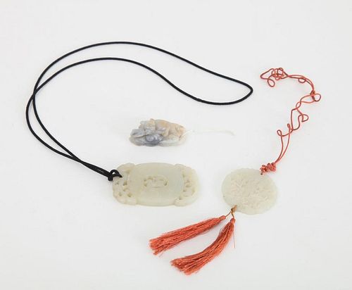 TWO CHINESE PIERCED AND CARVED JADE PENDANTS AND A CARVED JADE FELINE