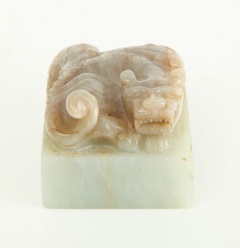 CHINESE CARVED PALE GREEN AND MOTTLED JADE CHOP