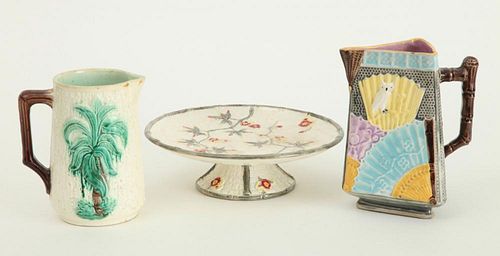 JAPONAISE" MAJOLICA TRIANGULAR PITCHER, A FAUX BARK PITCHER AND A STEMMED CAKE PLATTER"