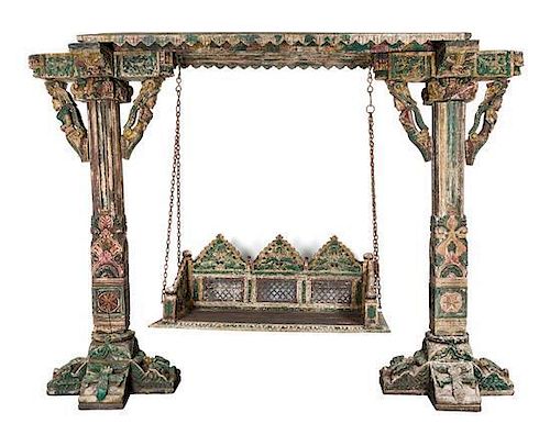 * An Indian Carved and Painted Wood Garden Swing Height 87 x width 116 x depth 29 inches.