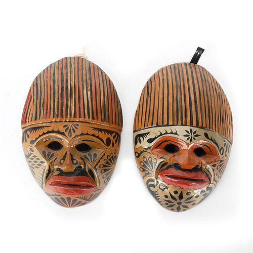A PAIR OF CARVED WOODEN TRIBAL MASKS