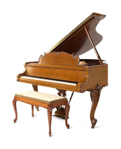 A Steinway & Sons Walnut Baby Grand Piano