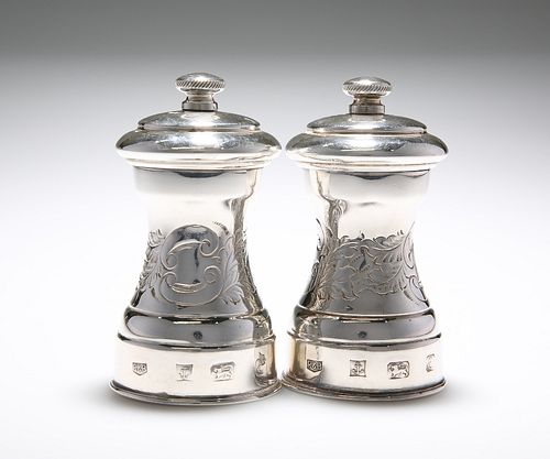 A PAIR OF SILVER PEPPER GRINDERS, ROBERTS & BELK, LONDON 1979, the waisted 