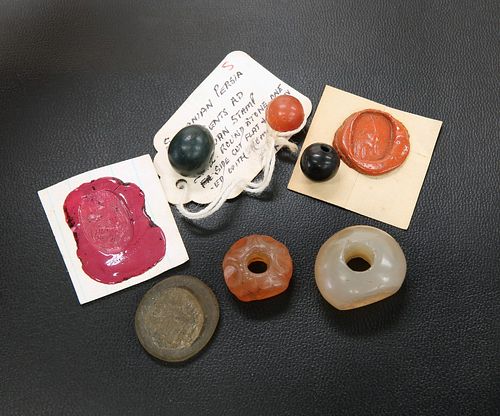 FOUR ROMAN INTAGLIOS, together with A GLASS SEAL AND A DRILLED BEAD. (6)