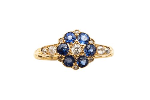 A SAPPHIRE AND DIAMOND CLUSTER RING, CIRCA 1923
 Centrally-set with an old 