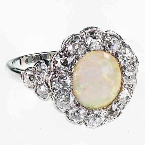 AN 18CT WHITE GOLD AND PLATINUM OPAL AND DIAMOND CLUSTER RING
 The round ca