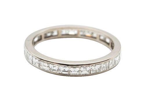 A DIAMOND ETERNITY RING
 Channel-set with a row of square step-cut diamonds