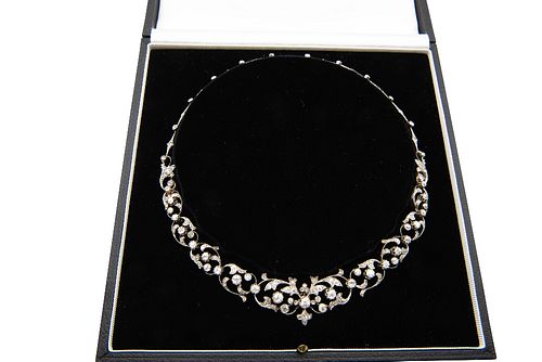 AN EARLY 20TH CENTURY DIAMOND NECKLACE
 The foliate openwork swags set thro