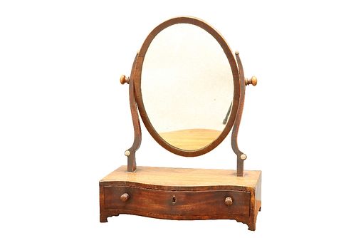 A GEORGE III MAHOGANY TOILET MIRROR, the oval mirror swivelling on uprights