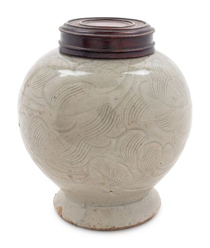 A Celadon Glazed Carved 'Floral' Porcelain Jar
Height 4 3/4 in., 12 cm.