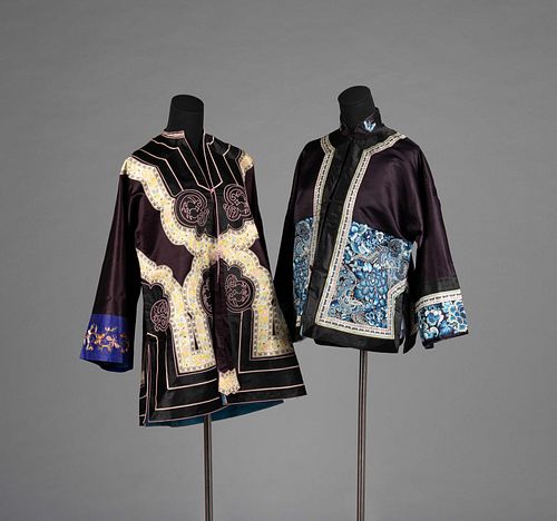 Two Black Ground Embroidered Silk Lady's CoatsLength of longer 39 in., 99 cm.