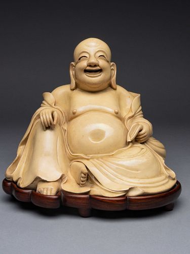 A White Glazed Figure of Budai BuddhaHeight 6 5/8 in., 16.8 cm.