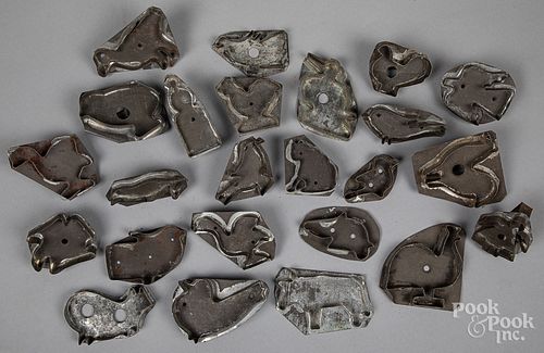 Collection of twenty-four tin cookie cutters