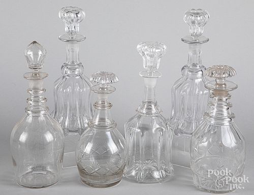 Six colorless glass decanters
