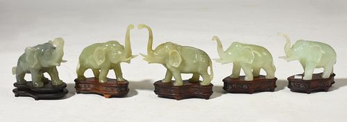Five small jade elephants on custom teak stands