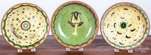 Three Isaac Stahl redware shallow bowls