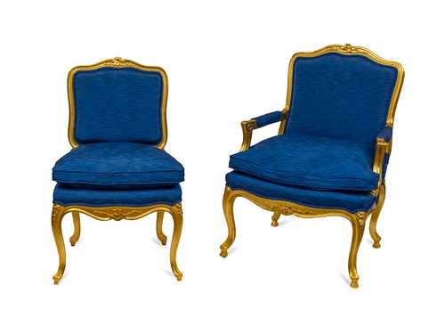 A Set of Fourteen Italian Louis XV Style Giltwood Dining Chairs Height 40 inches.
