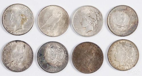 Three Morgan silver dollars, to include an 1881 O, an 1886, and a 1921