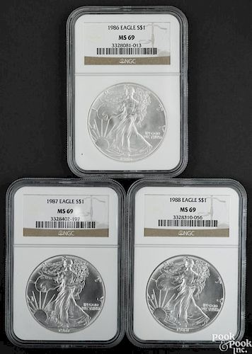 Three Walking Liberty silver Eagles, 1986-1988, NGC MS-69.