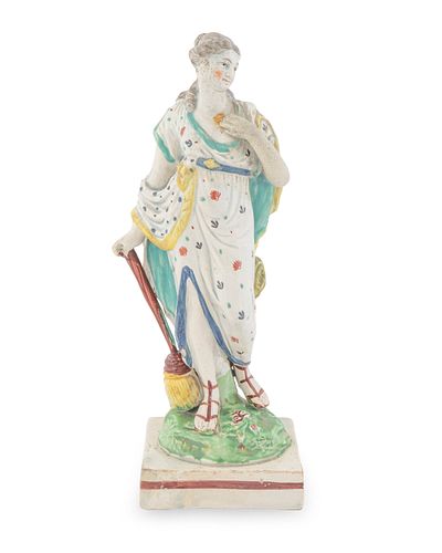 A Wedgwood Pearlware Figure of a Classical Woman with Broom
Height 8 1/4 x width 3 x depth 2 7/8 inches.