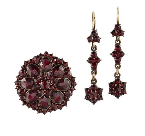 A GARNET-SET BROOCH AND EARRING SUITE
 The disc-sh