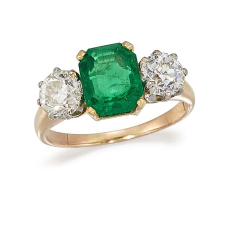 AN EMERALD AND DIAMOND THREE-STONE RING
 Set with 