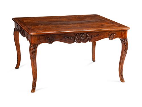 A Louis XV Style Carved Walnut Table
Height 30 1/2 x length 55 x depth 45 inches.