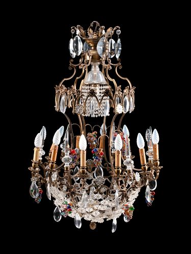 A Louis XV Style Patinated Bronze, Cut and Colored Glass Fourteen-Light Chandelier
Height 38 x diameter 26 inches.