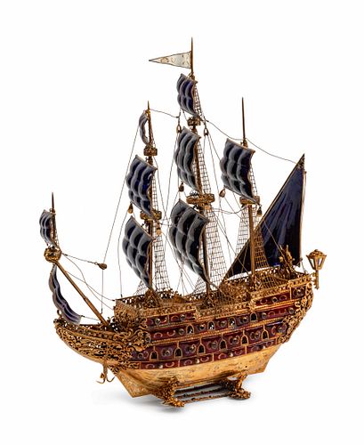 A Continental Jeweled Silvergilt and Enamel Model of a Galleon
Height 19 x length 15 1/2 x depth 6 inches.