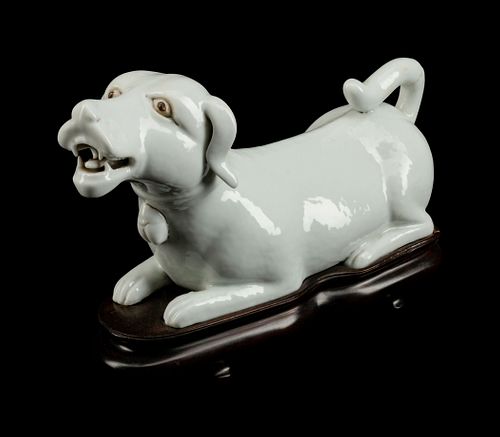 A Chinese Export Blanc de Chine Porcelain Figure of a Recumbent Dog
Height 4 1/2 x length 7 1/2 x depth 2 1/2 inches.