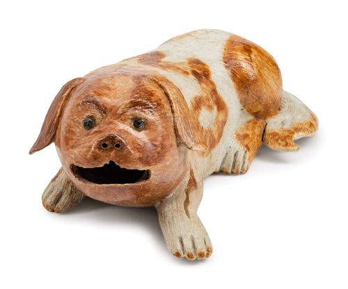 A Chinese Export Porcelain Figure of a Recumbent Dog
Height 2 1/2 x length 7 1/2 x depth 4 inches.