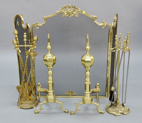 Five piece fireplace grouping to include a pair of brass andirons ht. 28 1/2", two sets of tools, along with ornate three-part screen.