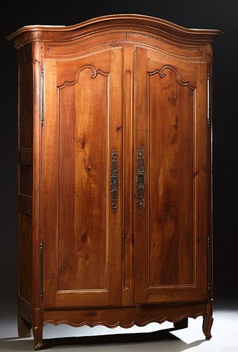 French Provincial Inlaid Carved Cherry Armoire, early 19th c., the stepped arched ogee crown over arched double doors with long iron...