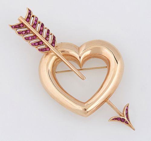 14K Yellow Gold and Ruby Heart Brooch, 20th c., the large heart pierced by an arrow with a ruby mounted "feather" fletching and arro...
